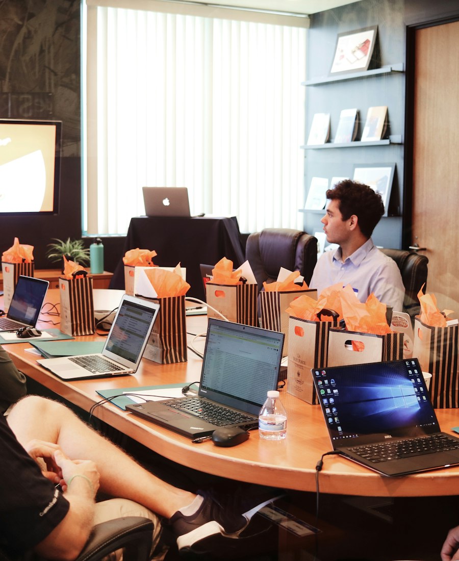 A team meeting around a table with laptops
