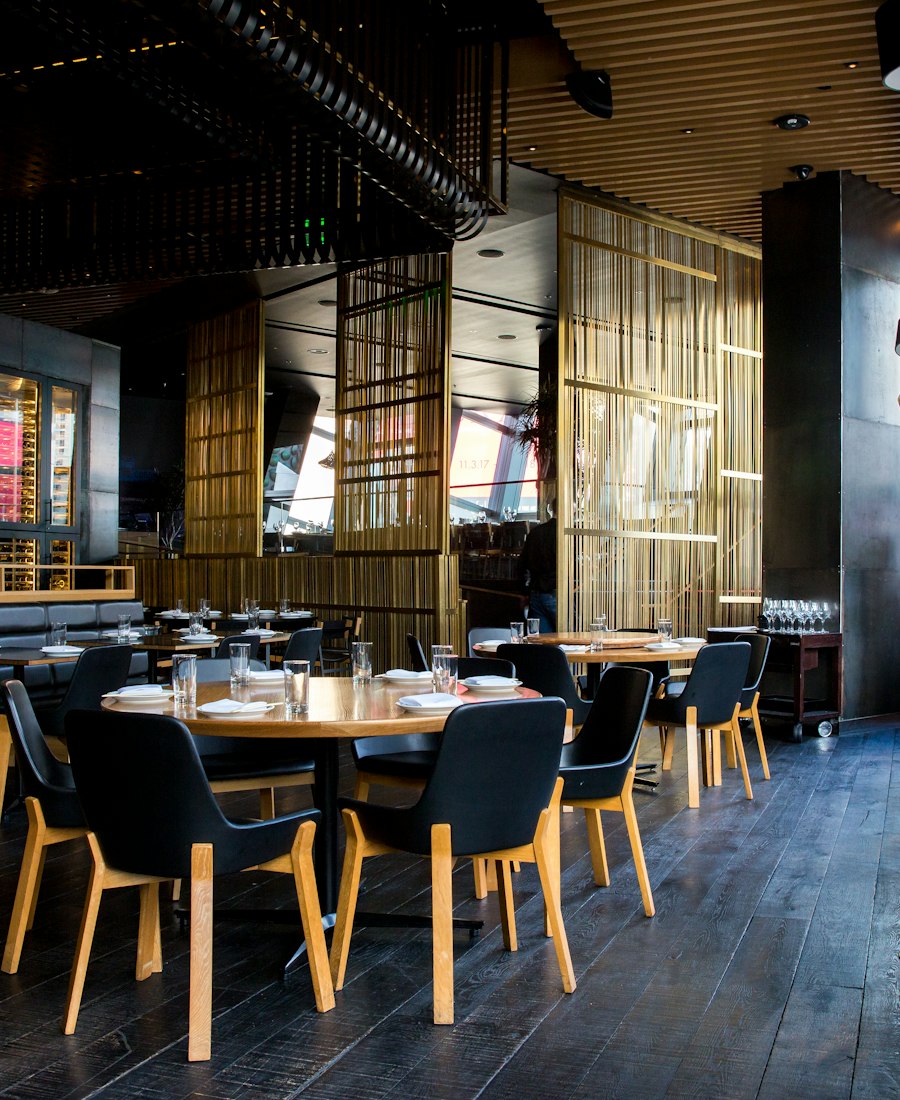 A modern restaurant dining room with warm lighting